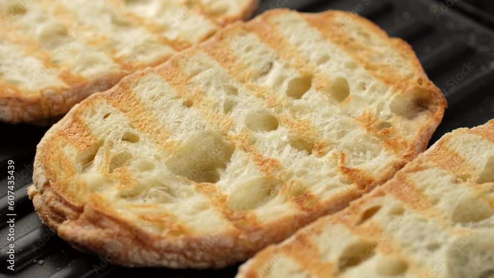Fresh ciabatta bread on grill, slider shot Fresh ciabatta bread on grill, slider shot