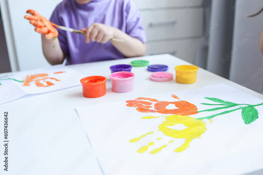Children's art workshop, the child makes a handprint with paints Children's art workshop, the child makes a handprint with paints
