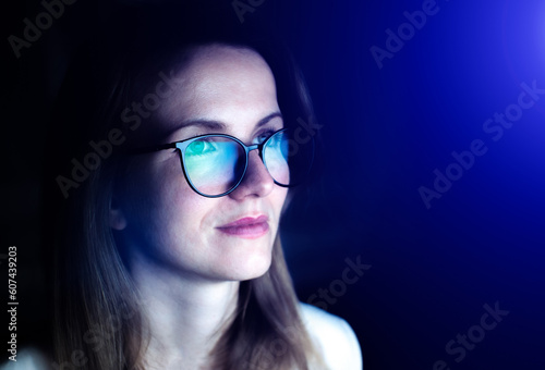 Business woman in glasses is working online at the laptop or computer. Social media influencer creating content. Programmer or designer work. Marketing and stock market.
