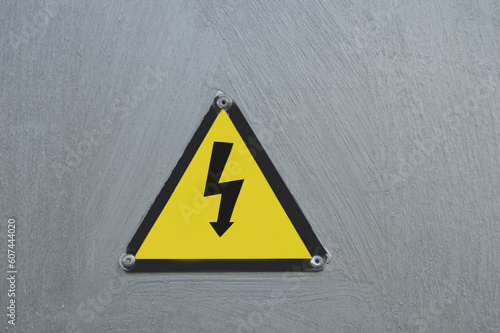 Sign warning of danger of electrocution on a metal door