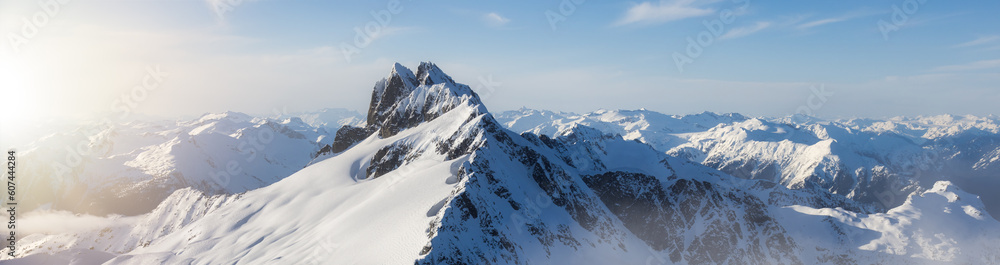 Obraz premium Rugged Canadian Mountain Peak Covered in Snow. Aerial Landscape