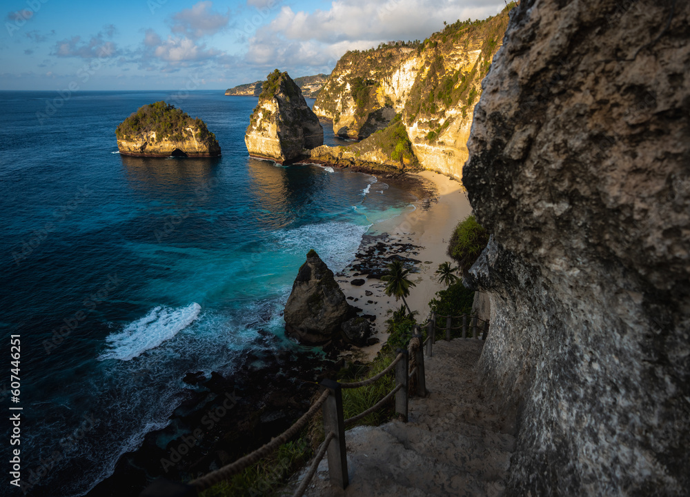 Stunning view of the Diamond Beach bathed by a turquoise sea during a beautiful sunrise. Diamond Beach is an untouched, white-sand and silky blue water bay on the eastern tip of Nusa Penida. Stunning view of the Diamond Beach bathed by a turquoise sea during a beautiful sunrise. Diamond Beach is an untouched, white-sand and silky blue water bay on the eastern tip of Nusa Penida.