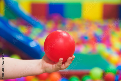 Creative development of children. The child plays with colored balls in the child development center photo