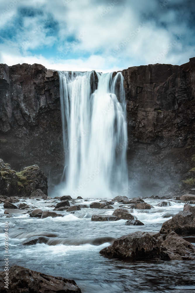 Moody Gufufoss waterfall flowing on summer in east fjords Moody Gufufoss waterfall flowing on summer in east fjords