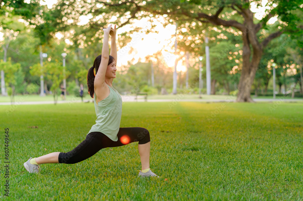 Female jogger. Fit young Asian woman with green sportswear stretching muscle in park before running and enjoying a healthy outdoor. Fitness runner girl in public park. Wellness being concept Female jogger. Fit young Asian woman with green sportswear stretching muscle in park before running and enjoying a healthy outdoor. Fitness runner girl in public park. Wellness being concept