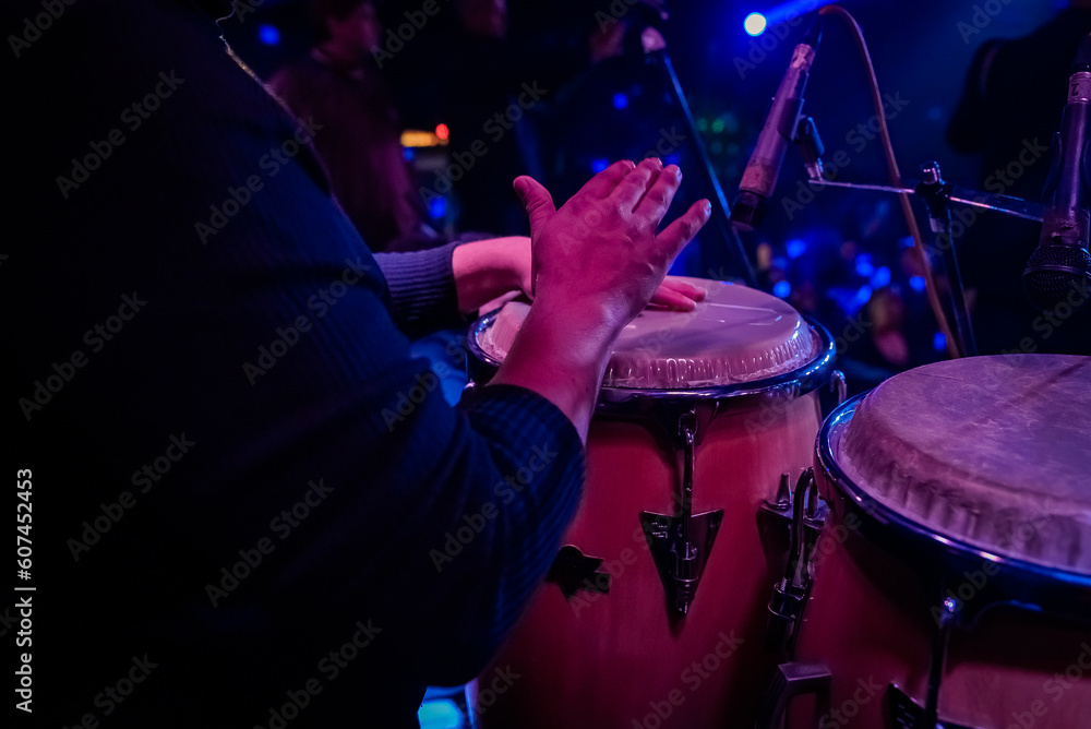 unrecognizable person playing congas, percussion musical instrument.  concept band of cumbia, salsa, latin music. Stock-Foto | Adobe Stock
