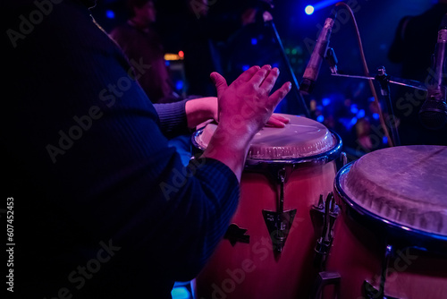 unrecognizable person playing congas, percussion musical instrument. concept band of cumbia, salsa, latin music.