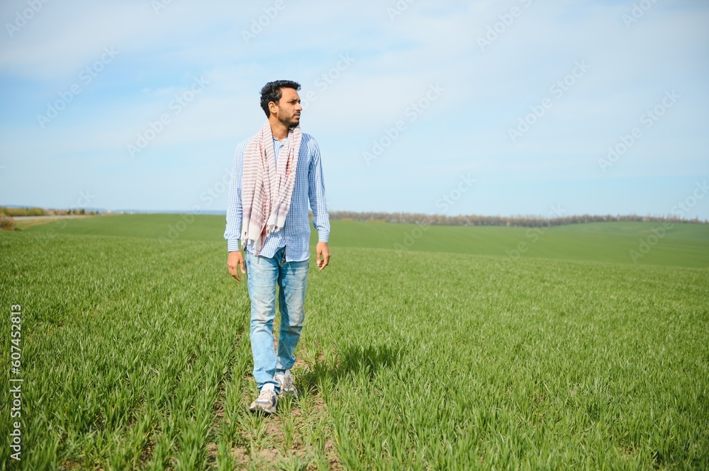 worry less ,indian farmer standing in his healthy wheat field