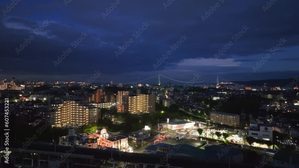Bright lights from cars and buildings at intersection in small city at night Bright lights from cars and buildings at intersection in small city at night