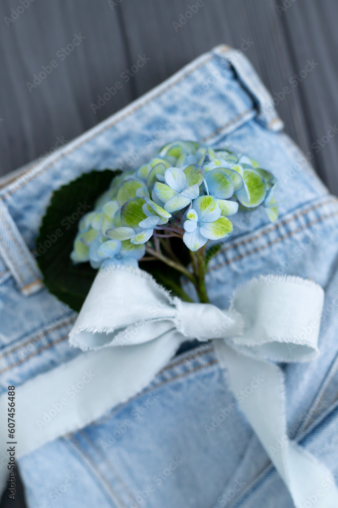 Hydrangea flowers and cute bow on denim background Hydrangea flowers and cute bow on denim background