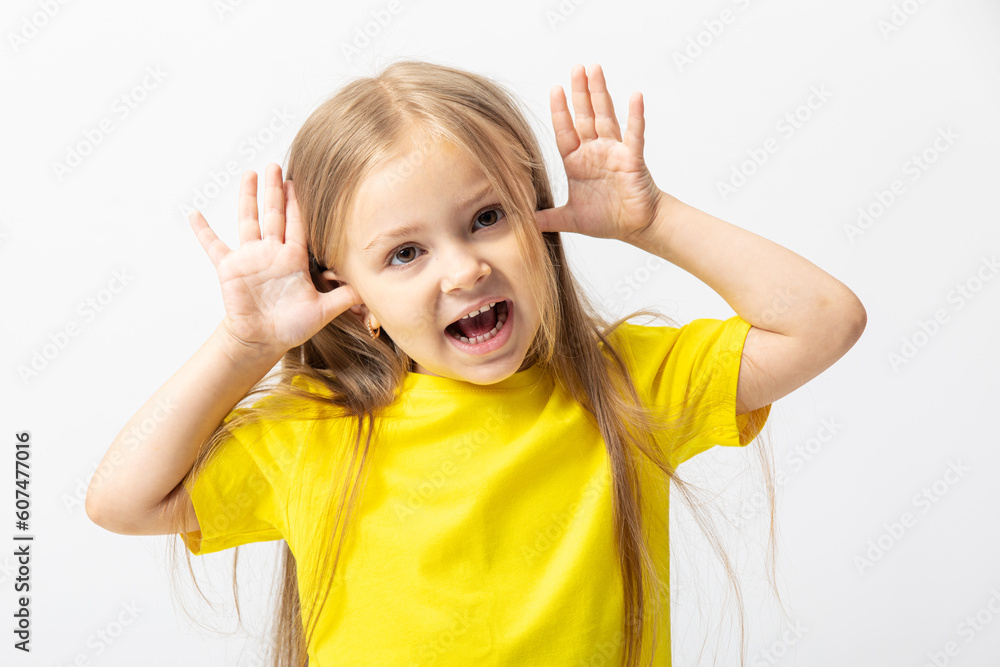 Portrait of a funny girl laughing at camera on a white background. Copy space. Studio shot. Happy childhood. Education. Portrait of a funny girl laughing at camera on a white background. Copy space. Studio shot. Happy childhood. Education.