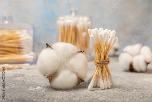White cotton swabs on a blue textured background. Cotton buds. Bamboo cotton buds. Eco friendly. Hygienic cotton swabs for ears. Place for text. Place to copy.