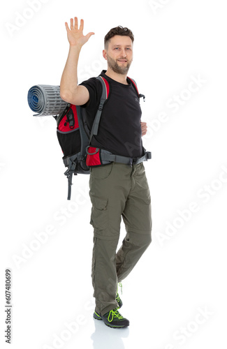 Full length portrait of hiker with a backpack , isolated on white background. Thirty years old man posing in studio. © Andrew Mayovskyy