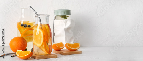 Bottle of orange infused water on table. Banner for design