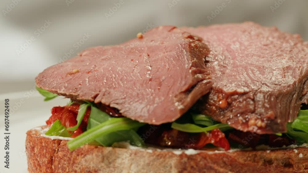 American pastrami sandwich in New York ham meet cuts. chef cooking Famous thick cut sous vide beef sandwich on restaurant cafe kitchen. American pastrami sandwich in New York ham meet cuts. chef cooking Famous thick cut sous vide beef sandwich on restaurant cafe kitchen.