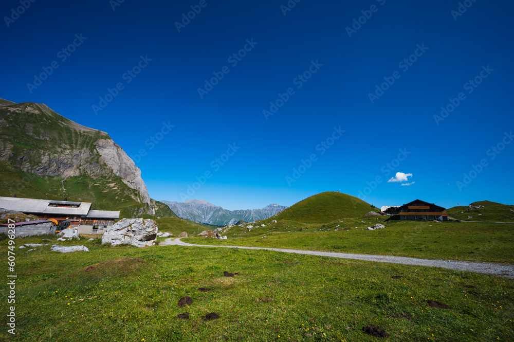 Fototapeta premium Bern, Switzerland - July 25, 2022 - View of Engstligenalp from the Engstligengrat hiking trail, Swiss Alps, Switzerland