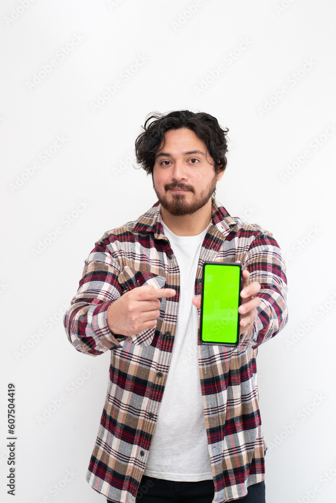 Vertical portrait of man holding cell phone with chroma key while are pointing it in white background Vertical portrait of man holding cell phone with chroma key while are pointing it in white background