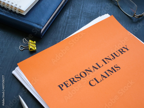 A stack of papers with personal injury claims on the table.