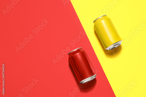 Metal cans of soda on color...
