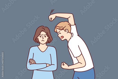 Aggressive man beats woman with violence because of jealousy and suspicion of infidelity or desire to get divorce. Nervous guy swinging his fist at girlfriend for domestic violence concept