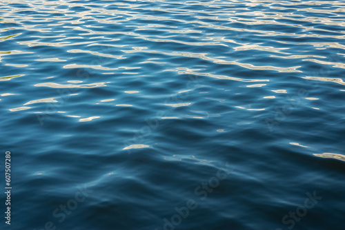 Beautiful wave pattern and reflections in the blue water of the sea. Suitable for background or wallpaper.