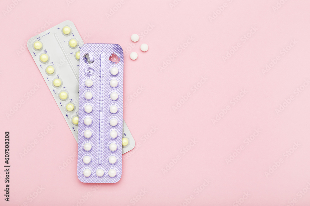 Oral contraceptive pills on pink background
