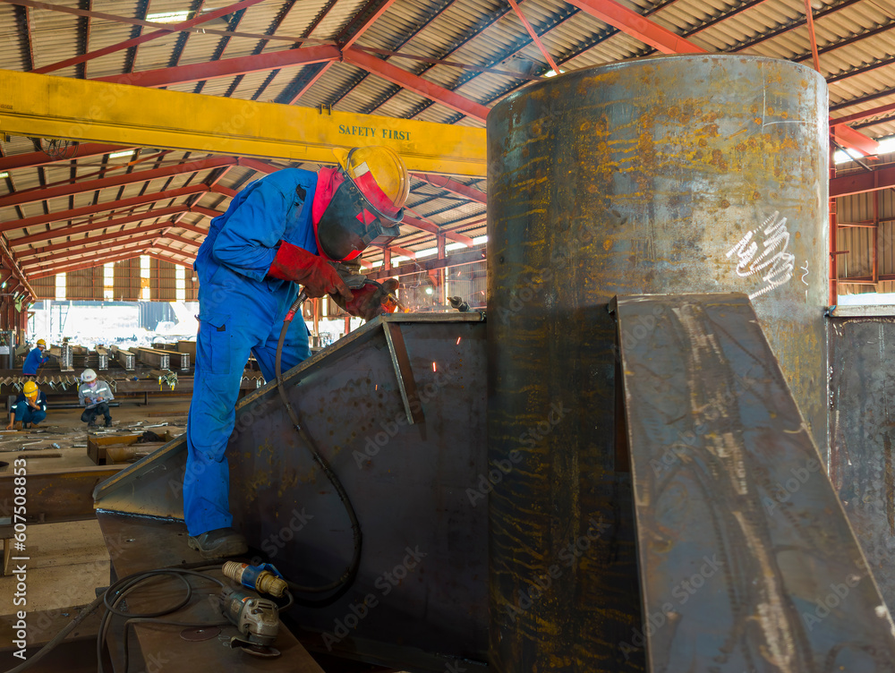 Welder is welding a steel plate for steel structure work with process
