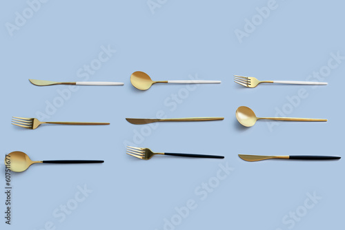 Golden cutlery on blue background © Pixel-Shot