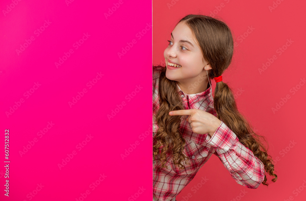 happy teen child behind blank pink paper with copy space for advertisement happy teen child behind blank pink paper with copy space for advertisement