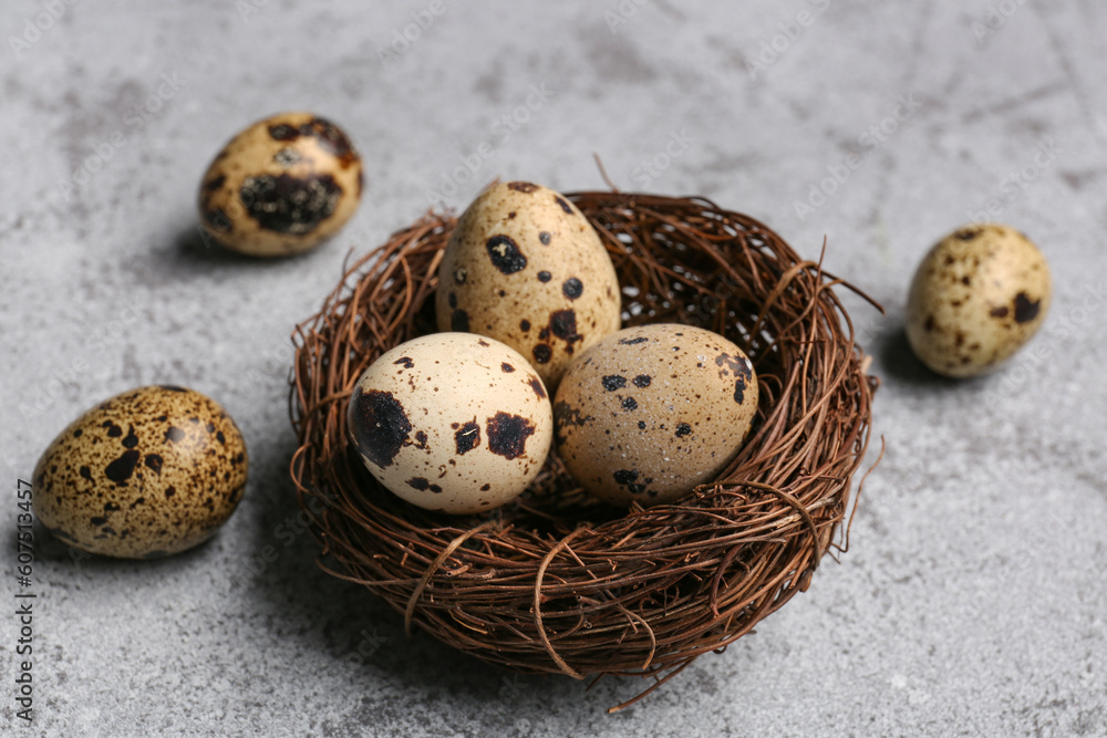Nest with fresh quail eggs on grunge background Nest with fresh quail eggs on grunge background