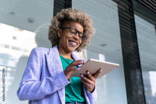  Young African American business woman working with digital tablet 