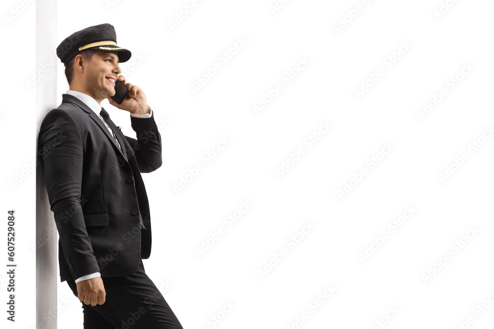 Chauffeur leaning on a wall and talking on a mobile phone Chauffeur leaning on a wall and talking on a mobile phone