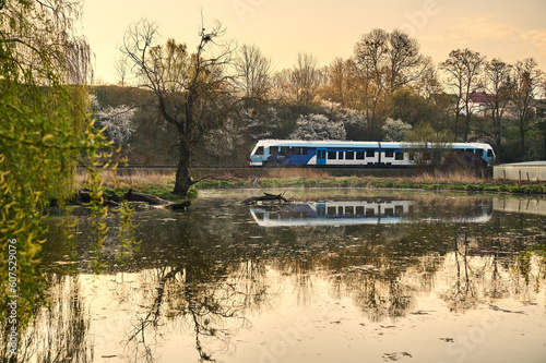 Passage of a passenger train on the lake photo