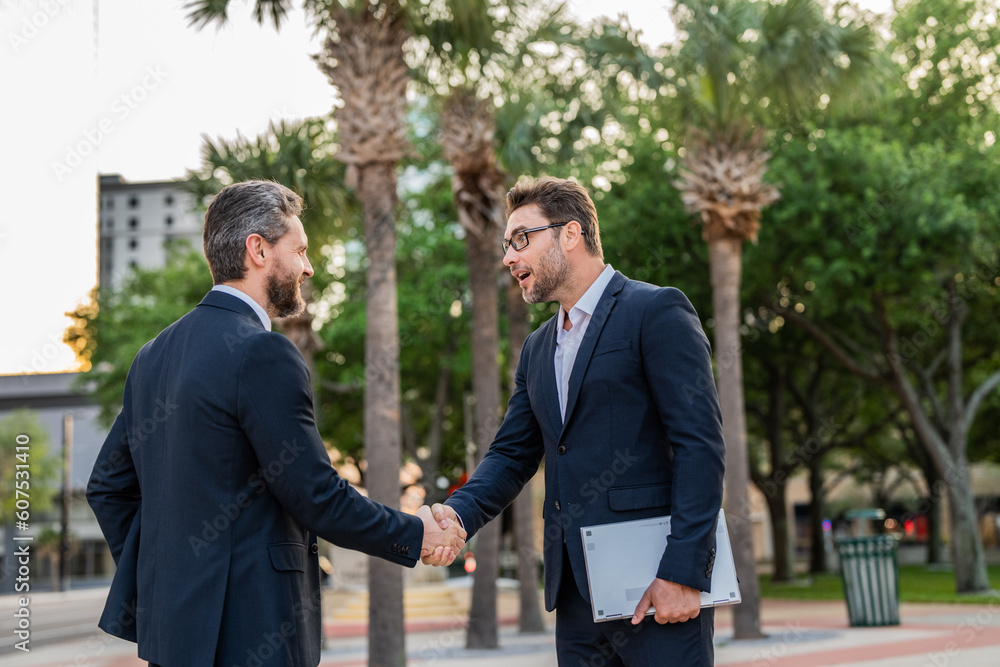 two amazed and happy business partners dealing negotiation outdoor two amazed and happy business partners dealing negotiation outdoor