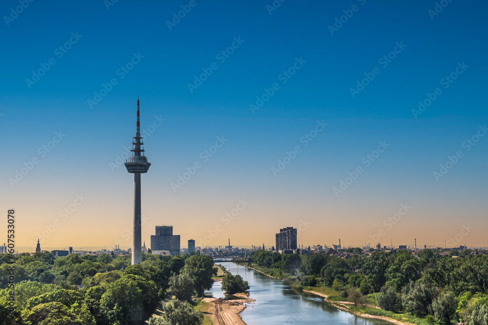 View to the Fernmeldeturm and river Neckar in Mannheim, Germany. Television TV telecommunications tower. Beautiful evening light. Copy space.