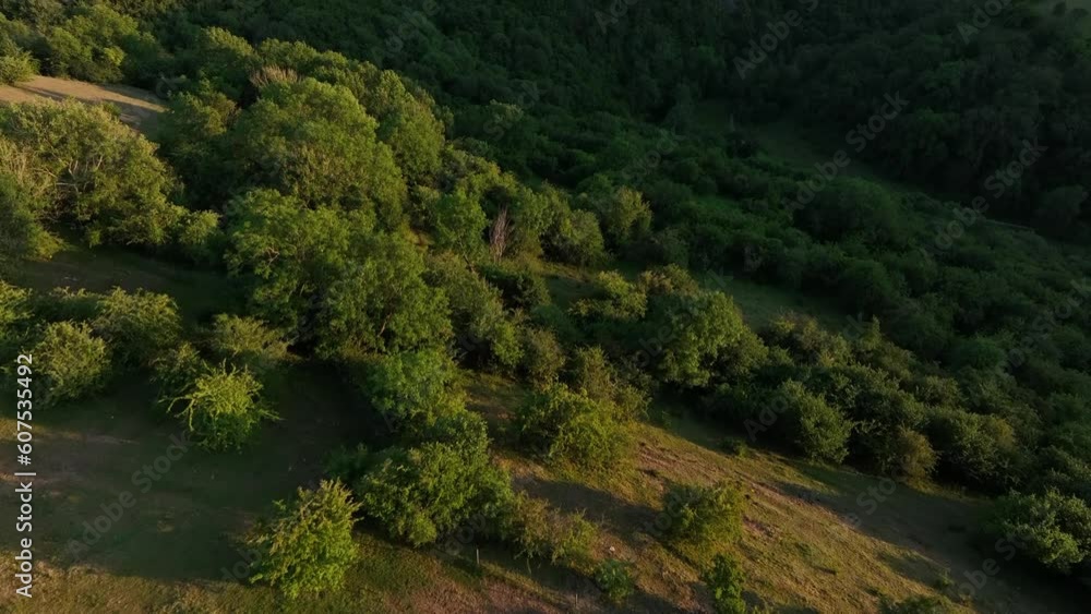 Aerial video of a man standing on a mountain and looking at the landscape Aerial video of a man standing on a mountain and looking at the landscape