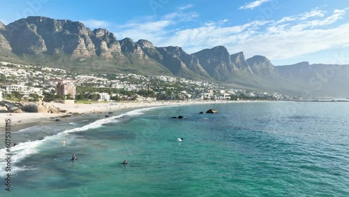 Aerial view of surfers in clear blue sea at Camps Bay, Cape Town, South Africa. photo