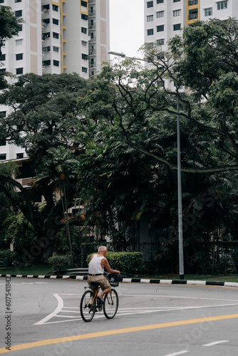 Old man cruising around the City of Singapore