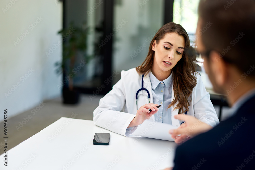 A female doctor discussed the diagnosis with a male patient at the clinic. A female doctor discussed the diagnosis with a male patient at the clinic.