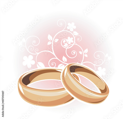 Gold wedding rings and floral pattern on a white background.