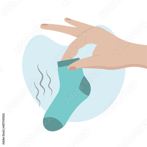 Hand holds dirty blue sock. Household and laundry concept