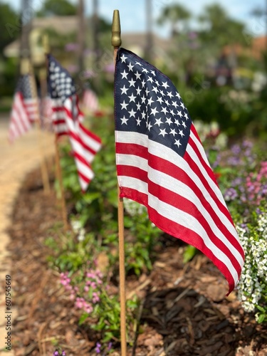 American flags flying in a garden area