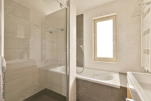 a bathroom with a sink  mirror and shower stall in the corner next to the bathtub on the wall