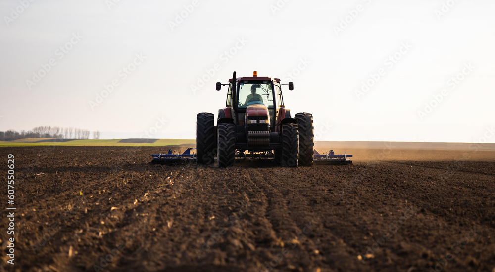 Farmer preparing his field in a tractor Farmer preparing his field in a tractor