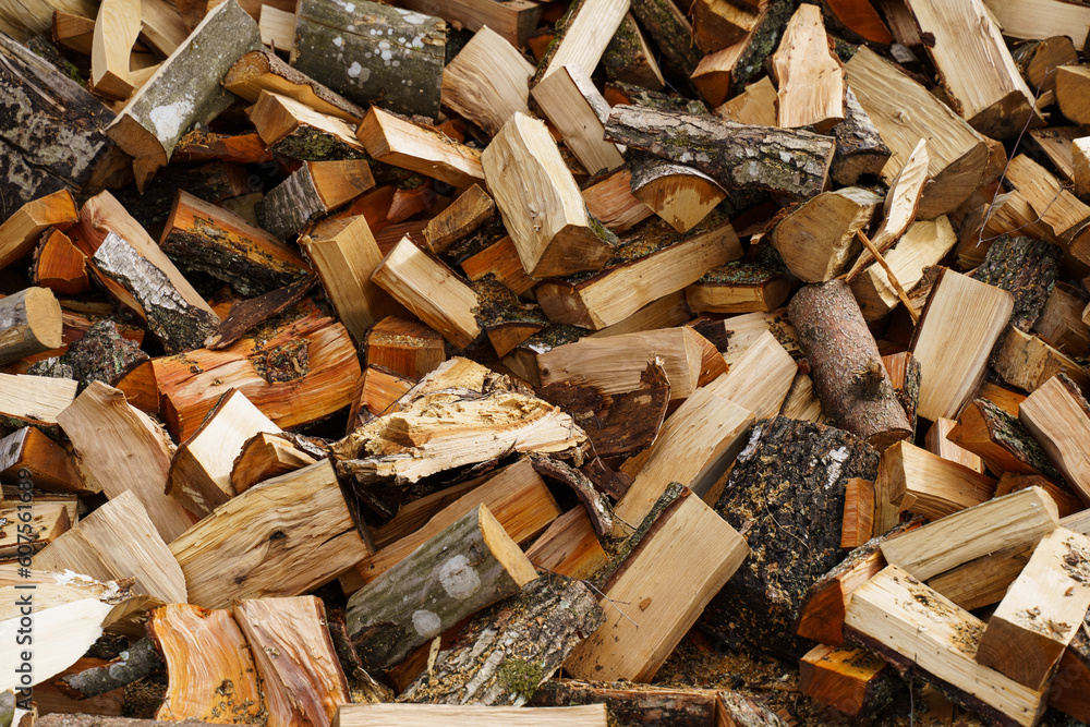 Dry chopped firewood in a pile. Abstraction and background Dry chopped firewood in a pile. Abstraction and background