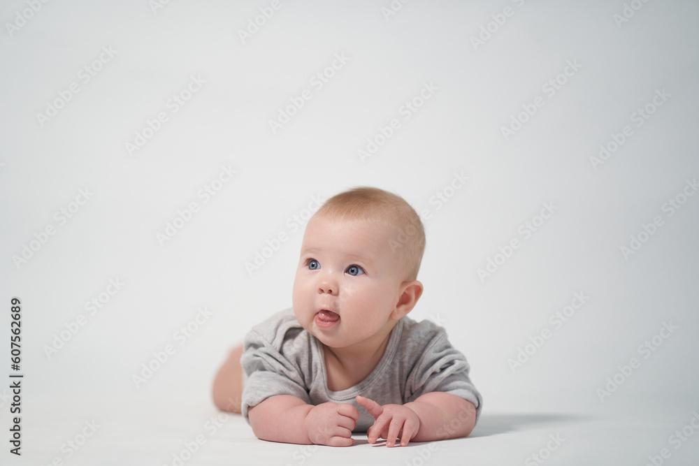 thoughtful baby looks around. photography on a light background of a newborn baby thoughtful baby looks around. photography on a light background of a newborn baby