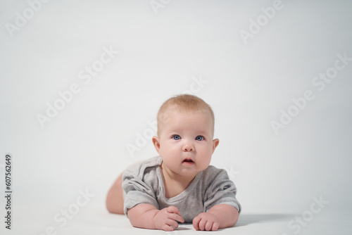 Portrait of a baby on a light background. baby lying on stomach