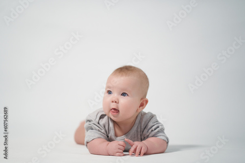 thoughtful baby looks around. photography on a light background of a newborn baby