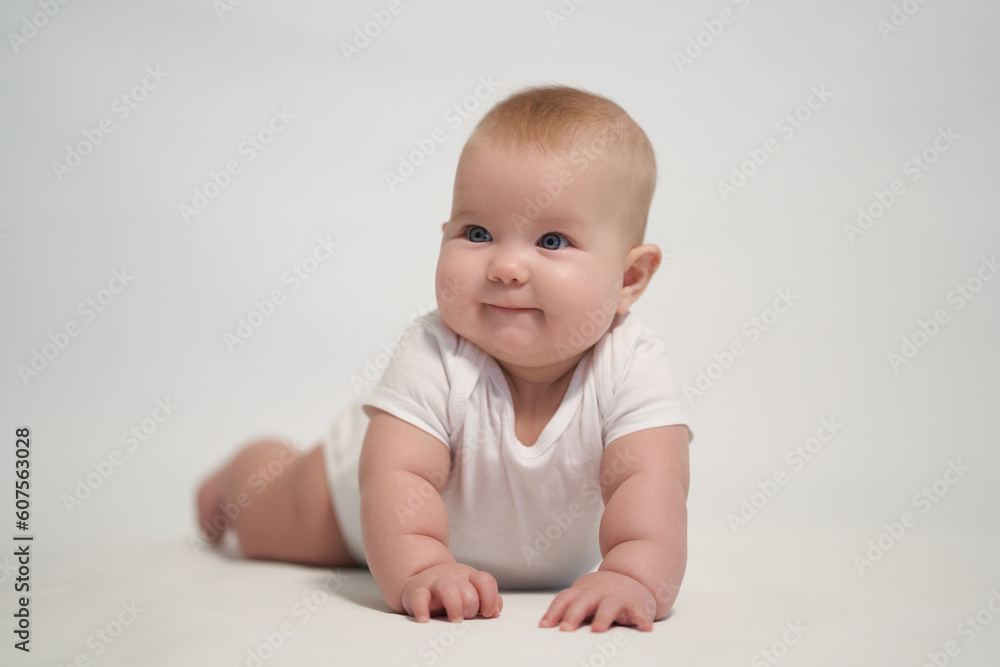 Smiling newborn baby. the photo was taken against a light background Smiling newborn baby. the photo was taken against a light background