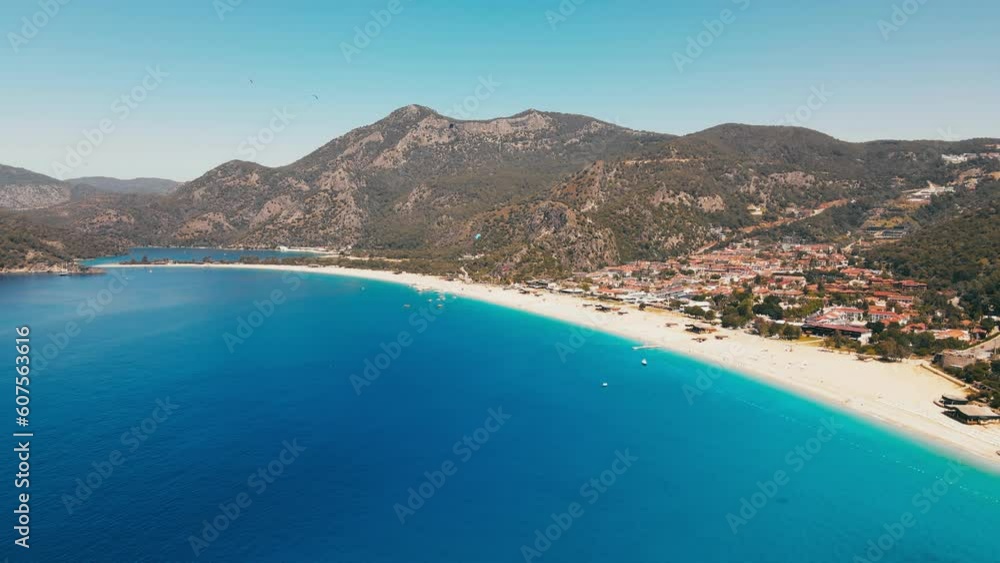 Established aerial shot of Oludeniz resort village with blue lagoon on likya footpath in Turkey Established aerial shot of Oludeniz resort village with blue lagoon on likya footpath in Turkey